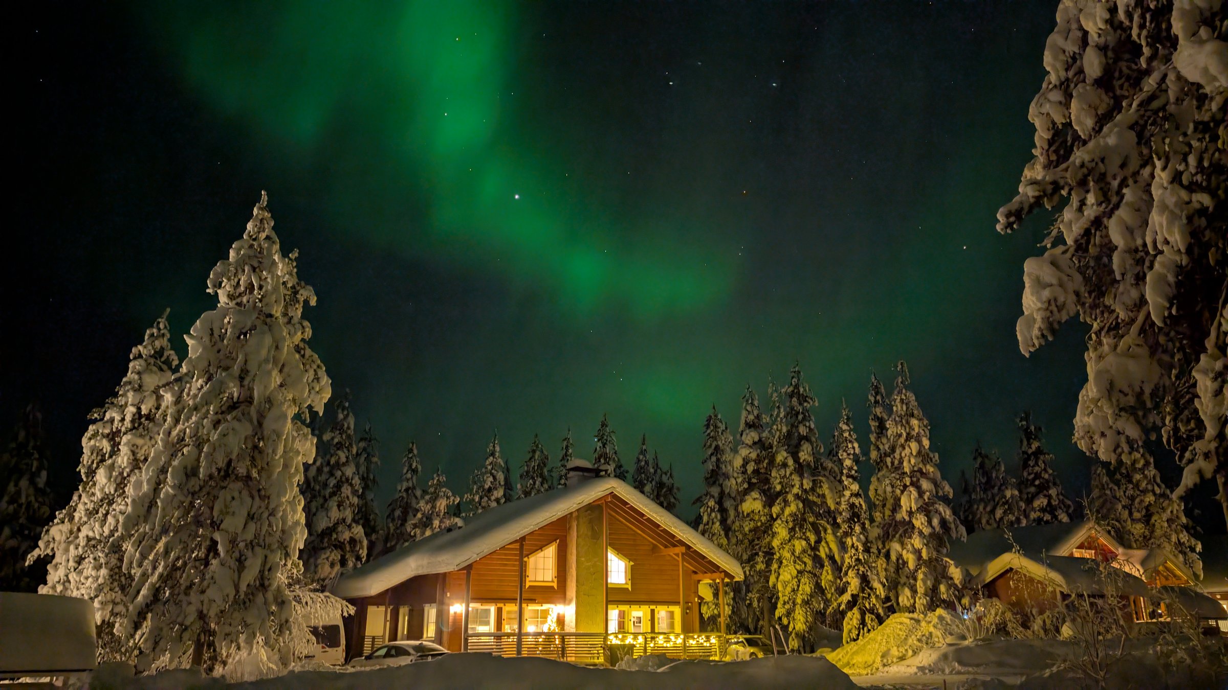 Revontulet Chalet Nulkan yllä talviyönä.